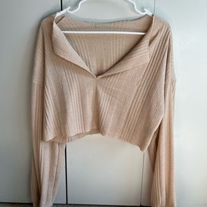 Cream colored cropped long sleeve top